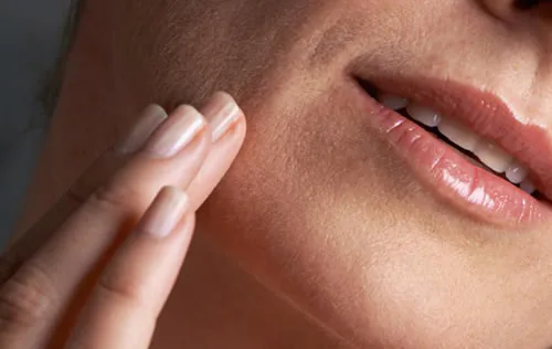 hands-on-womans-face